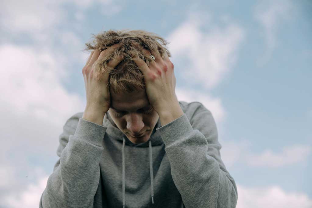 man with head in hands